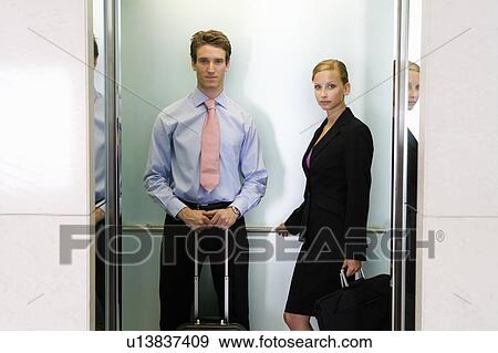 Stock Photo - A businessman and woman with suitcases. Fotosearch