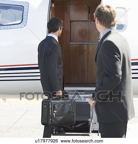 A businessman boarding a plane View Large Photo Image Stock Photograph - A businessman boarding a plane. Fotosearch