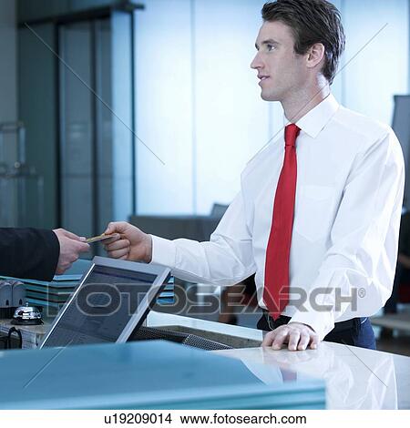 A businessman checking in/out View Large Photo Image Picture - A businessman checking in/out. Fotosearch