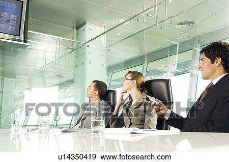 Stock Photo - A businessman giving a presentation at a meeting. Fotosearch