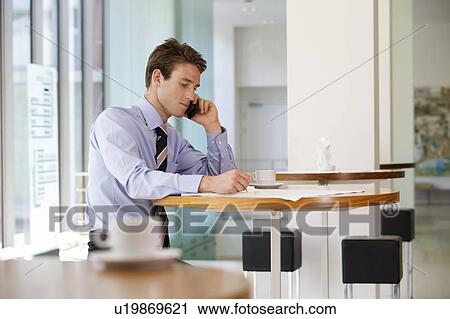 Stock Image - A businessman making a diary appointment. Fotosearch
