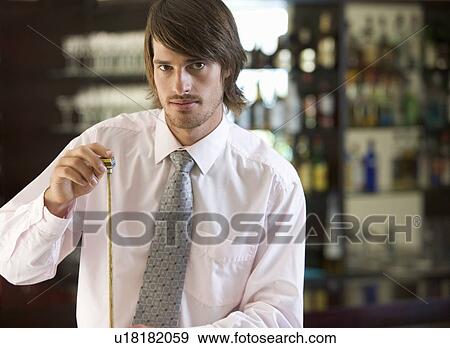 A businessman playing pool in a bar View Large Photo Image Stock Photo - A businessman playing pool in a bar. Fotosearch