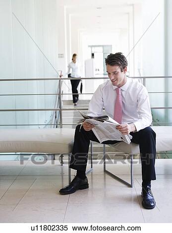 A businessman reading a paper View Large Photo Image Stock Photography - A businessman reading a paper. Fotosearch