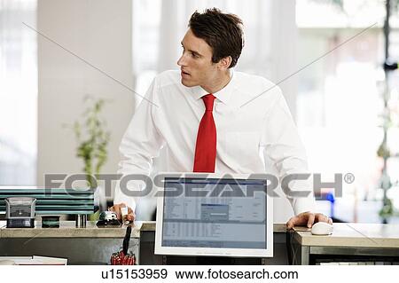 Stock Photo - A businessman waiting for service. Fotosearch