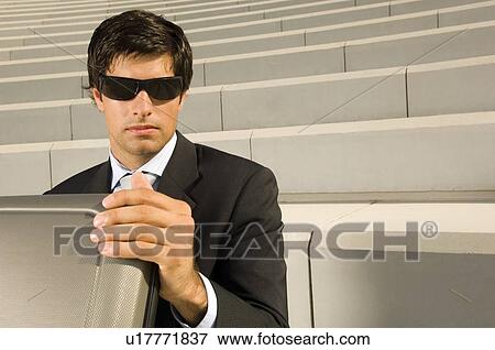 A businessman with a suitcase View Large Photo Image Stock Photo - A businessman with a suitcase. Fotosearch