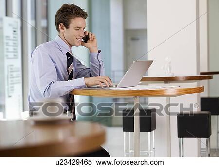 A businessman working on a laptop computer View Large Photo Image Stock Photography - A businessman working on a laptop computer. Fotosearch
