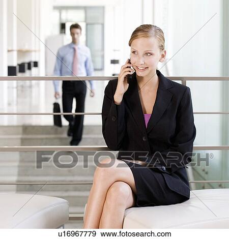 Stock Photo - A businesswoman talking on a mobile phone. Fotosearch