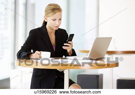 A businesswoman talking on a mobile phone View Large Photo Image Stock Photograph - A businesswoman talking on a mobile phone. Fotosearch