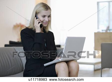 A businesswoman working on a laptop View Large Photo Image Stock Image - A businesswoman working on a laptop. Fotosearch