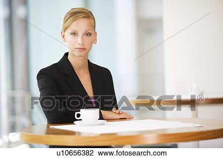 Stock Image - A businesswomen drinking coffee. Fotosearch