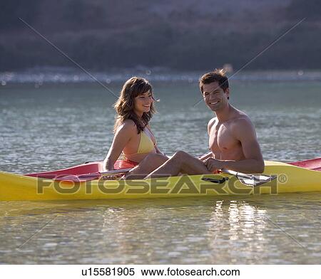 Stock Photography - A couple canoeing on a lake. Fotosearch
