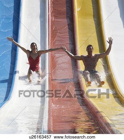 A couple coming down a slide in a waterpark View Large Photo Image Stock Photo - A couple coming down a slide in a waterpark. Fotosearch