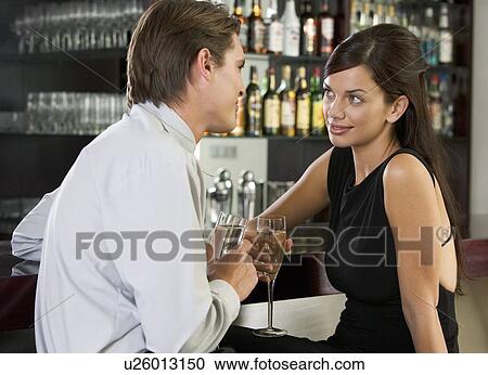 A couple drinking champagne in a bar View Large Photo Image Stock Image - A couple drinking champagne in a bar. Fotosearch