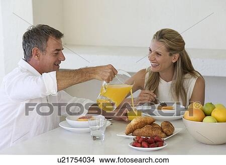 A couple eating breakfast View Large Photo Image Picture - A couple eating breakfast. Fotosearch