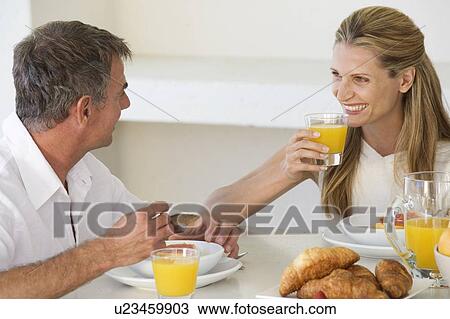 Stock Image - A couple eating breakfast. Fotosearch