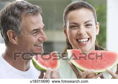 A couple eating watermelon View Large Photo Image Stock Image - A couple eating watermelon. Fotosearch