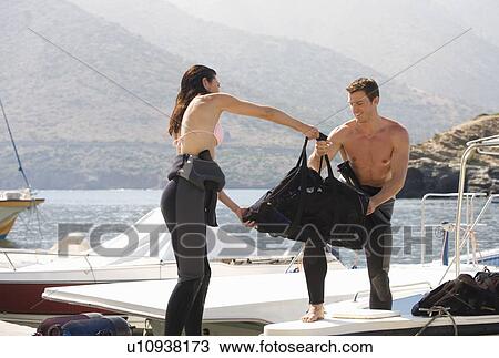 Stock Image - A couple going scuba diving on holiday. Fotosearch