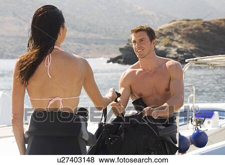 A couple going scuba diving on holiday View Large Photo Image Stock Photo - A couple going scuba diving on holiday. Fotosearch