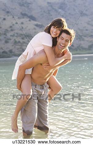 Stock Image - A couple having fun in a lake. Fotosearch