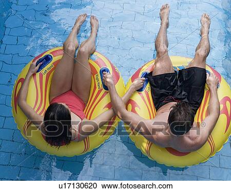 Stock Image - A couple having fun in a waterpark. Fotosearch