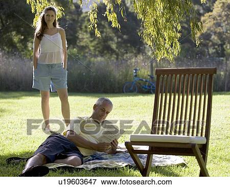 A couple in the garden in the shade of a tree View Large Photo Image Stock Photo - A couple in the garden in the shade of a tree. Fotosearch