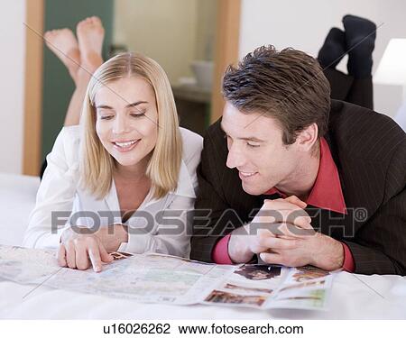 A couple reading a brochure in a hotel bedroom View Large Photo Image Stock Image - A couple reading a brochure in a hotel bedroom. Fotosearch