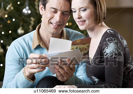 A couple reading Christmas cards View Large Photo Image Stock Photo - A couple reading Christmas cards. Fotosearch