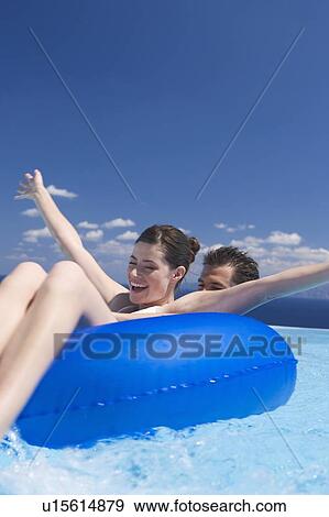 Stock Photo - A couple relaxing in a pool. Fotosearch