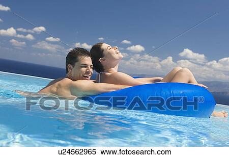 A couple relaxing in a pool View Large Photo Image Stock Photography - A couple relaxing in a pool. Fotosearch