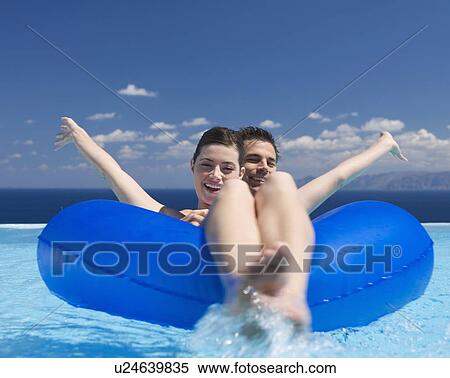 Stock Photography - A couple relaxing in a pool. Fotosearch