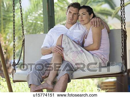 A couple relaxing on a swing View Large Photo Image Stock Image - A couple relaxing on a swing. Fotosearch