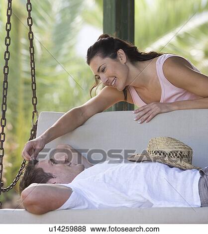 A couple relaxing on a swing View Large Photo Image Stock Photo - A couple relaxing on a swing. Fotosearch