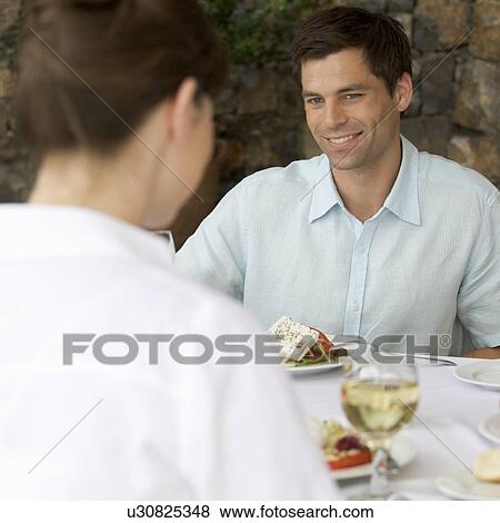 Stock Photo - A couple sharing a romantic meal. Fotosearch