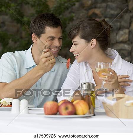A couple sharing a romantic meal View Large Photo Image Stock Photograph - A couple sharing a romantic meal. Fotosearch