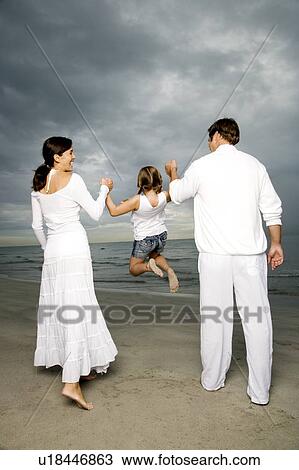 A couple with their daughter on a beach View Large Photo Image Stock Image - A couple with their daughter on a beach. Fotosearch