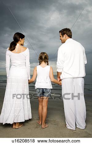 A couple with their daughter on a beach View Large Photo Image Stock Photo - A couple with their daughter on a beach. Fotosearch