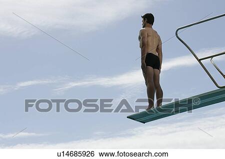 A diver standing on a diving board View Large Photo Image Stock Photograph - A diver standing on a diving board. Fotosearch