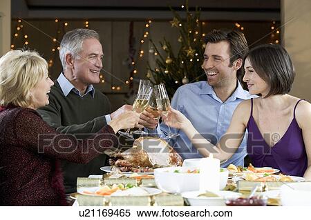 A family celebrating Christmas with a glass of champagne View Large Photo Image Stock Photography - A family celebrating Christmas with a glass of champagne. Fotosearch
