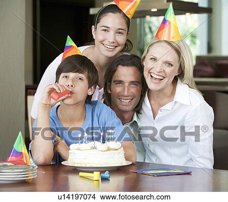 A family celebrating their son's birthday View Large Photo Image Picture - A family celebrating their son's birthday. Fotosearch