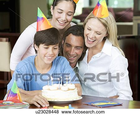 A family celebrating their son's birthday View Large Photo Image Stock Photo - A family celebrating their son's birthday. Fotosearch
