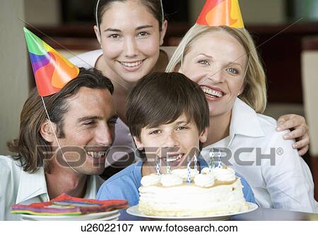 Stock Photo - A family celebrating their son's birthday. Fotosearch