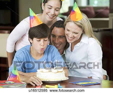 A family celebrating their son's birthday View Large Photo Image Stock Photography - A family celebrating their son's birthday. Fotosearch