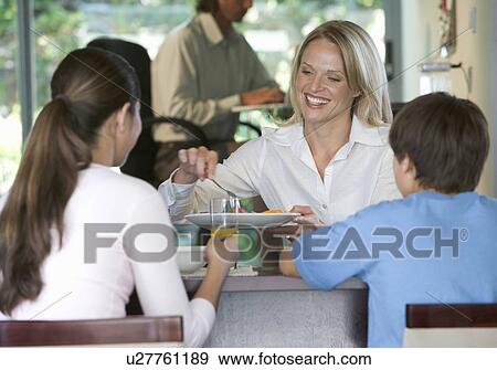 A family eating breakfast View Large Photo Image Stock Photo - A family eating breakfast. Fotosearch