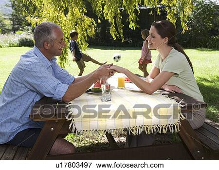 Stock Photo - A family in the garden. Fotosearch
