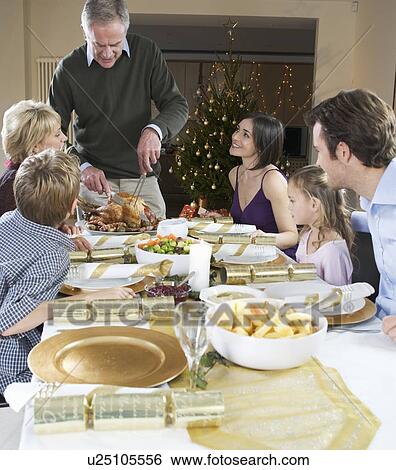 A family sitting down for Christmas dinner View Large Photo Image Stock Photograph - A family sitting down for Christmas dinner. Fotosearch
