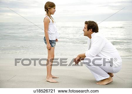 A father and daughter on a beach View Large Photo Image Stock Image - A father and daughter on a beach. Fotosearch