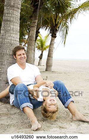 A father and his son on a beach View Large Photo Image Stock Image - A father and his son on a beach. Fotosearch
