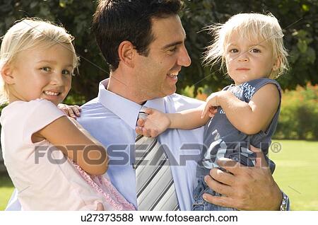 A father with his two children View Large Photo Image Stock Photo - A father with his two children. Fotosearch