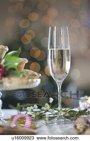 Stock Image - A glass of champagne and mistletoe. Fotosearch