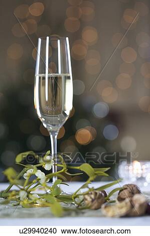 A glass of champagne and mistletoe View Large Photo Image Stock Image - A glass of champagne and mistletoe. Fotosearch